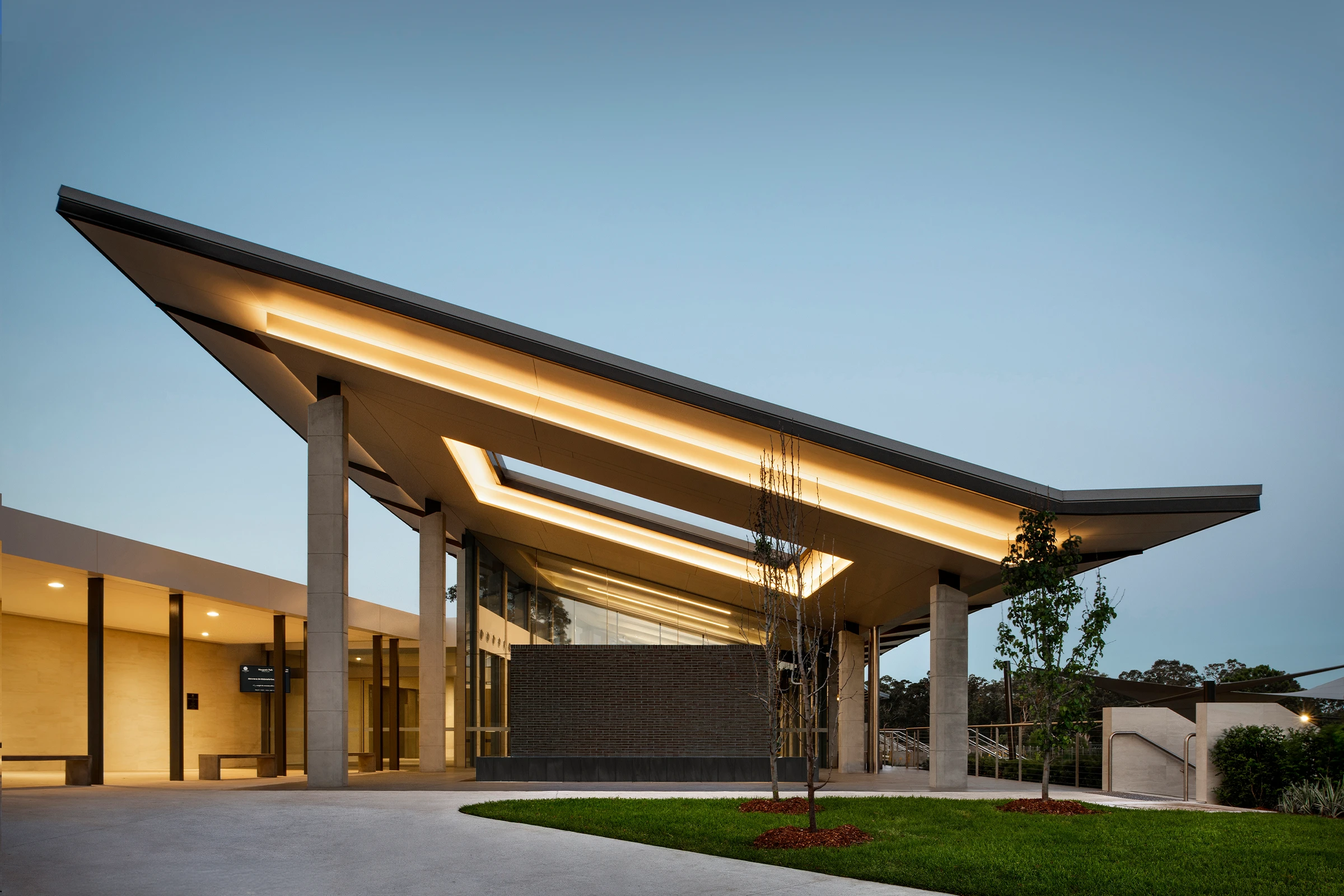 Wallumatta Function Centre at Macquarie Park Cemetery, Northern Sydney, by Wetherill Architects, with a soaring skillion roof resting lightly on concrete columns