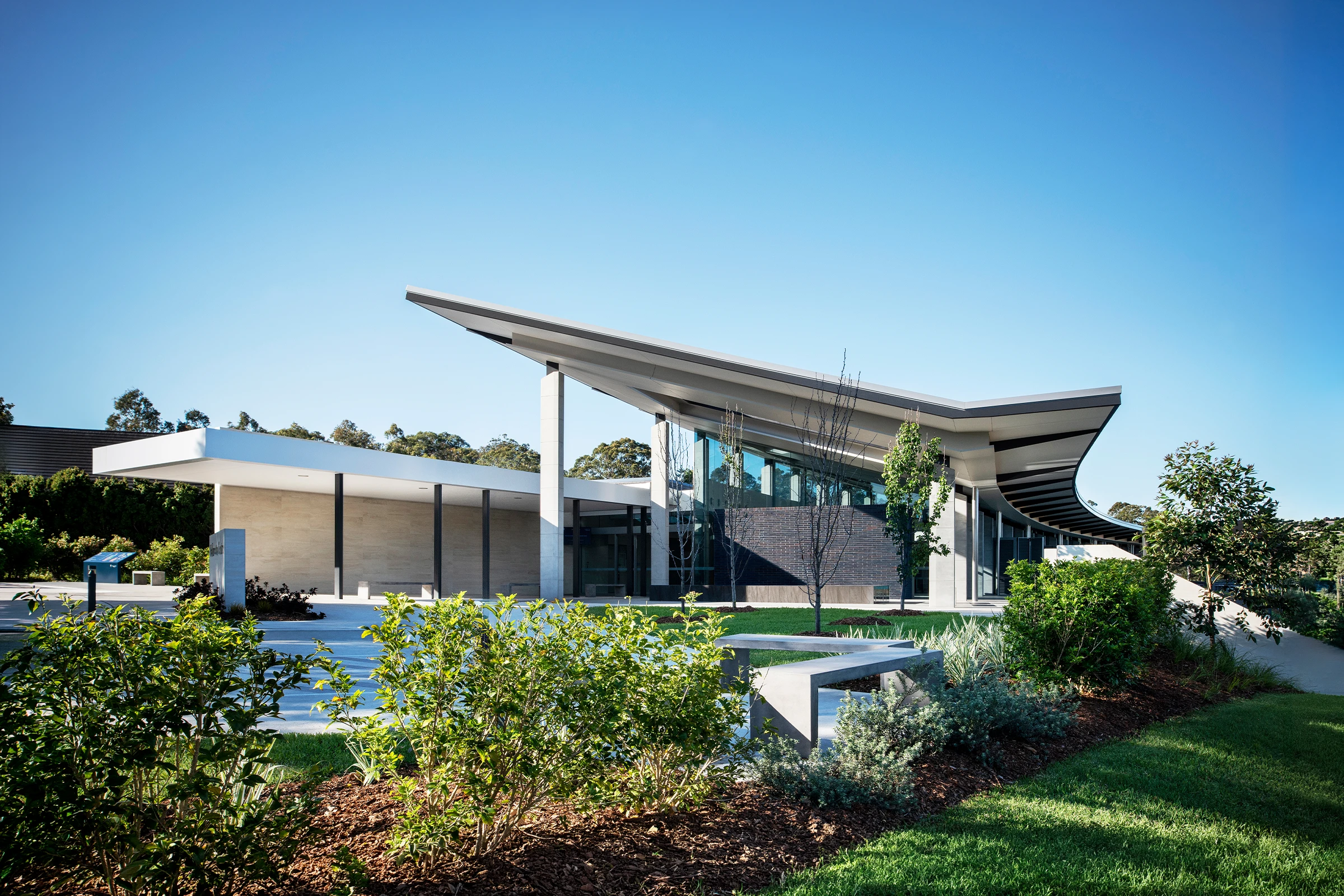 Wallumatta Function Centre covered entryway with soaring skillion roof and landscaped gardens
