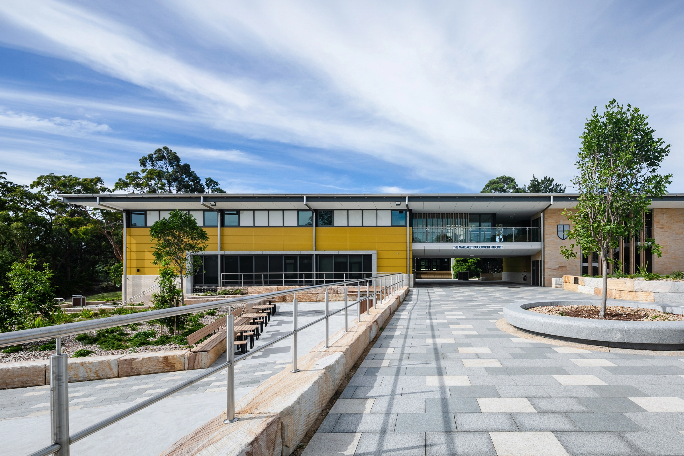 Northholm Grammar School Margaret Duckworth Precinct with elevated paved walkway and landscaped school grounds