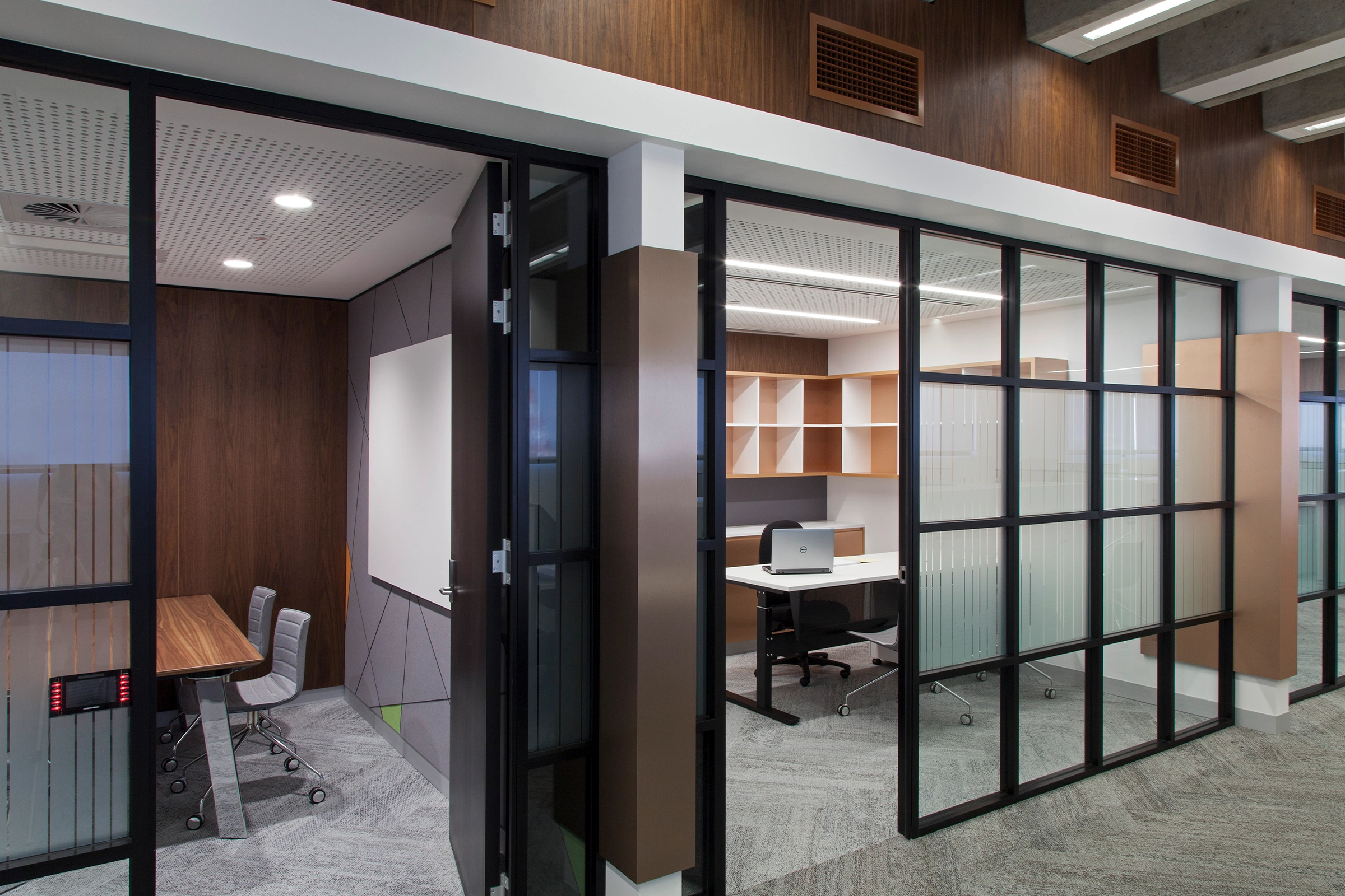 UTS Building 1 Levels 20–21 workplace meeting rooms with black-framed glass partitions and warm timber finishes