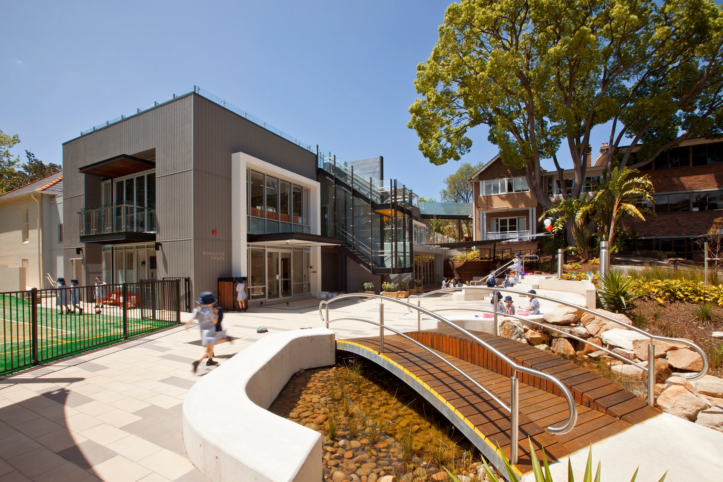 Student running through the Wenona Woodstock Junior School courtyard in North Sydney, designed by Wetherill Architects