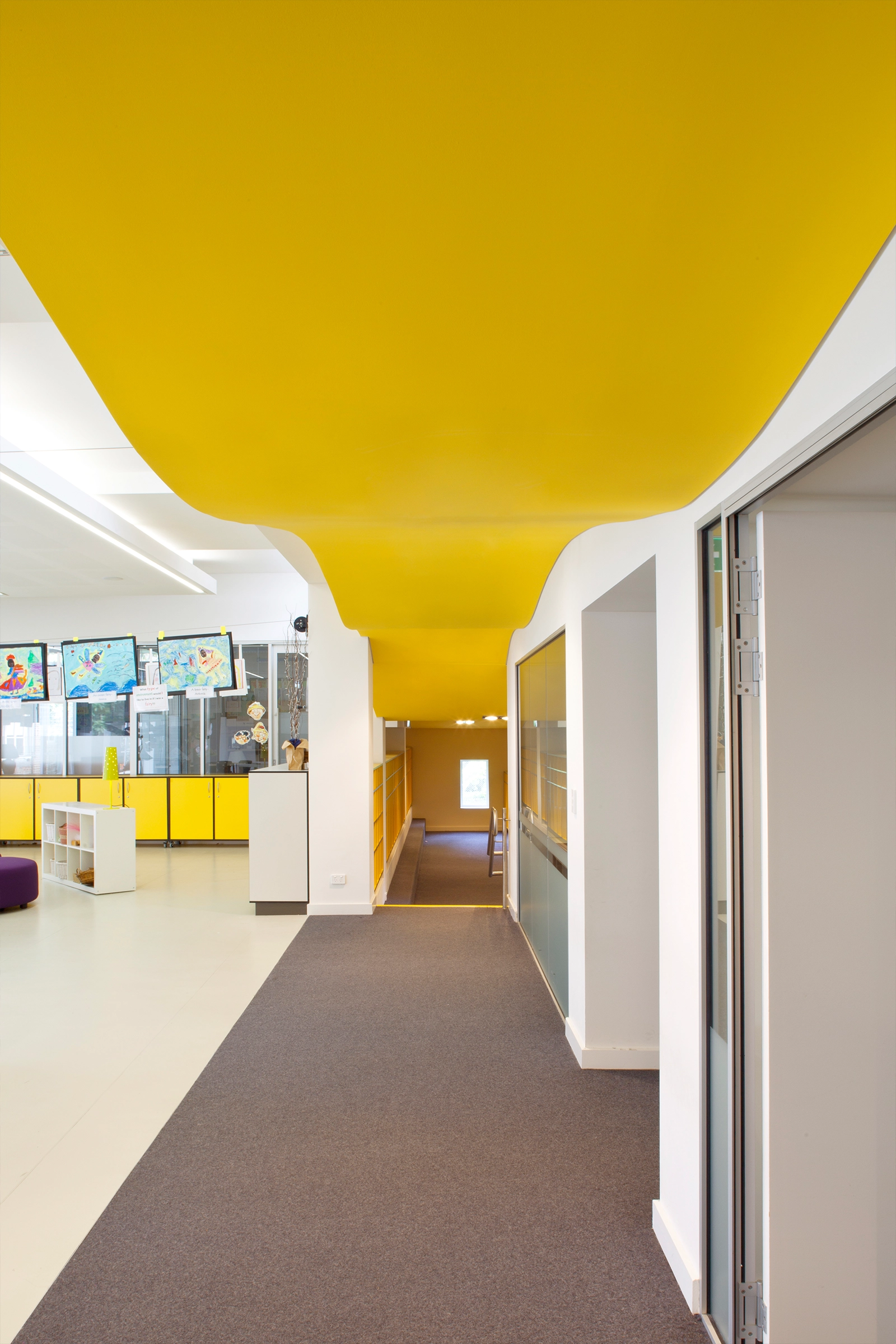 Wenona Woodstock Junior School interior hallway with playful yellow wavy ceiling